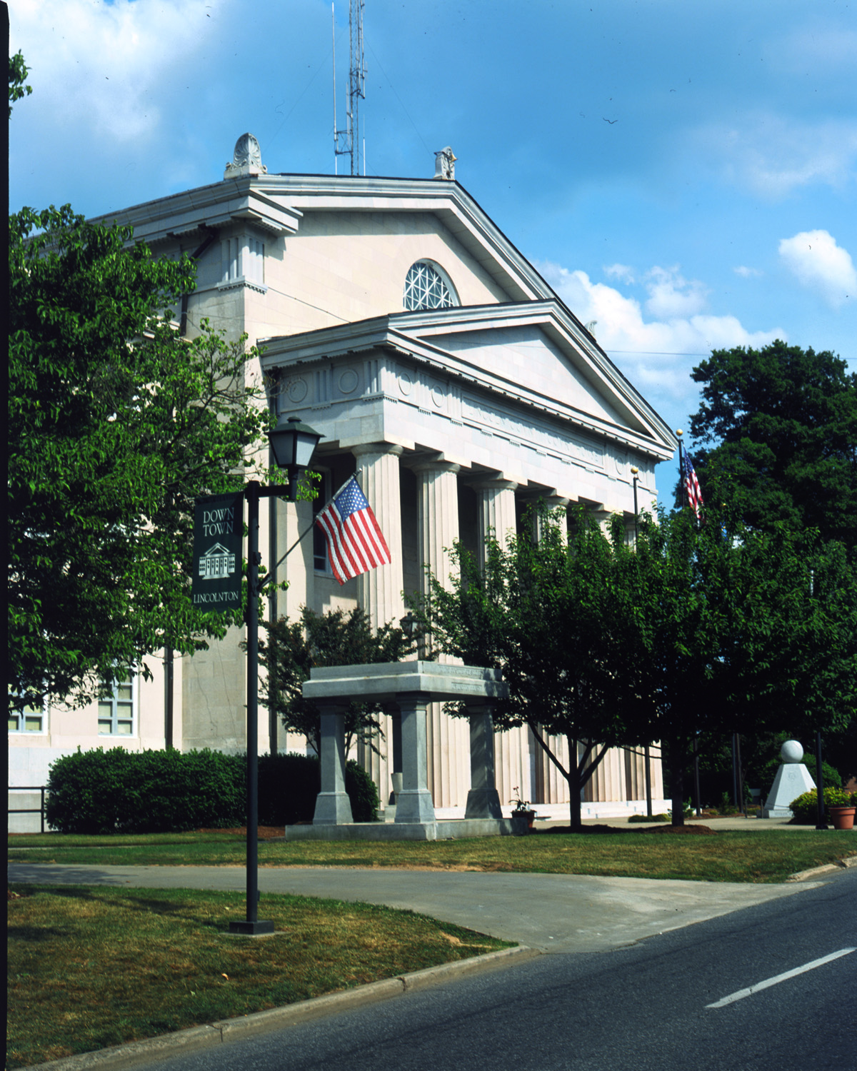 Pillared buidling with American flag flying from l